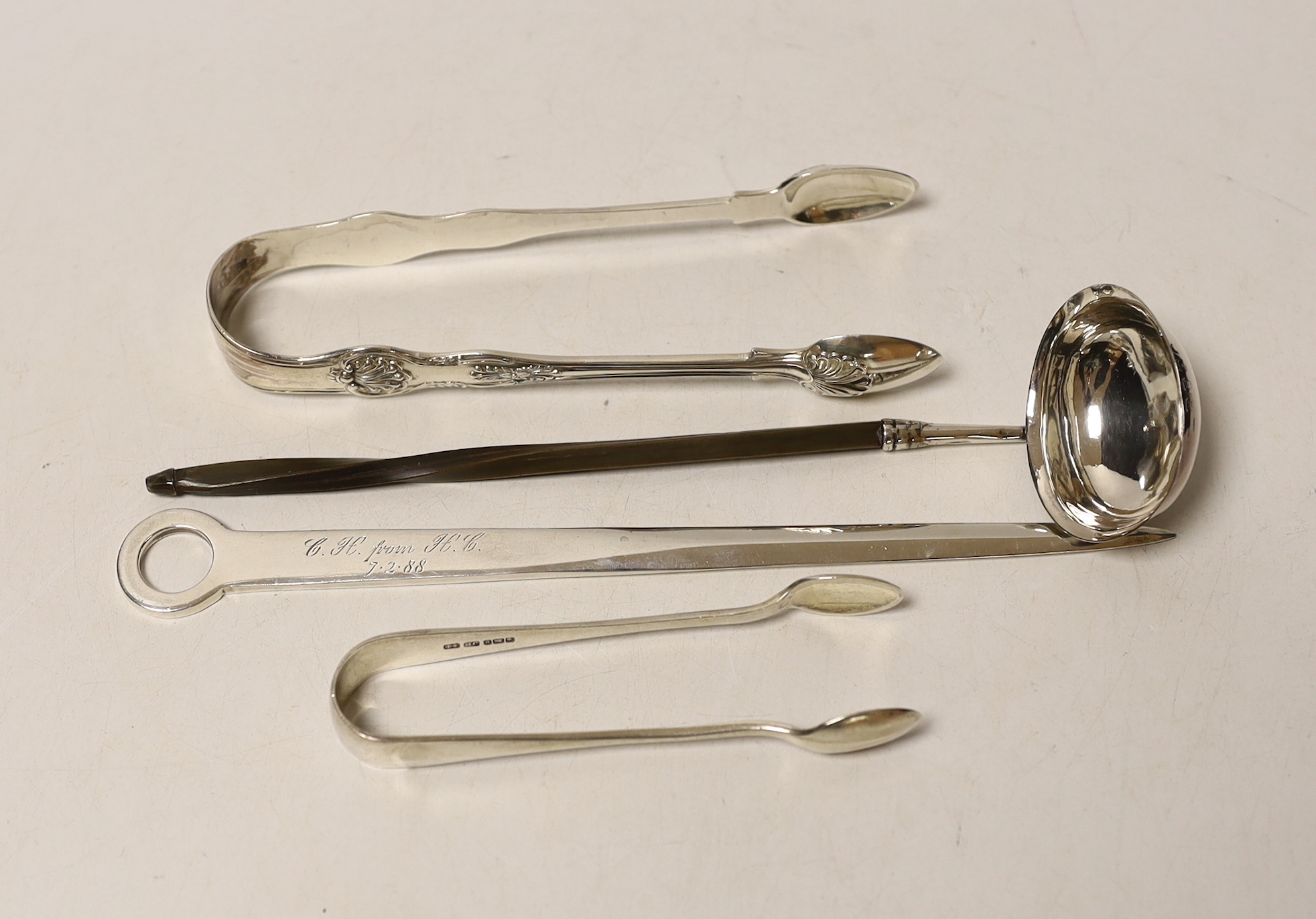 Two pairs of silver sugar tongs, including Victorian King's pattern a white metal toddy ladle and a modern silver letter opener.